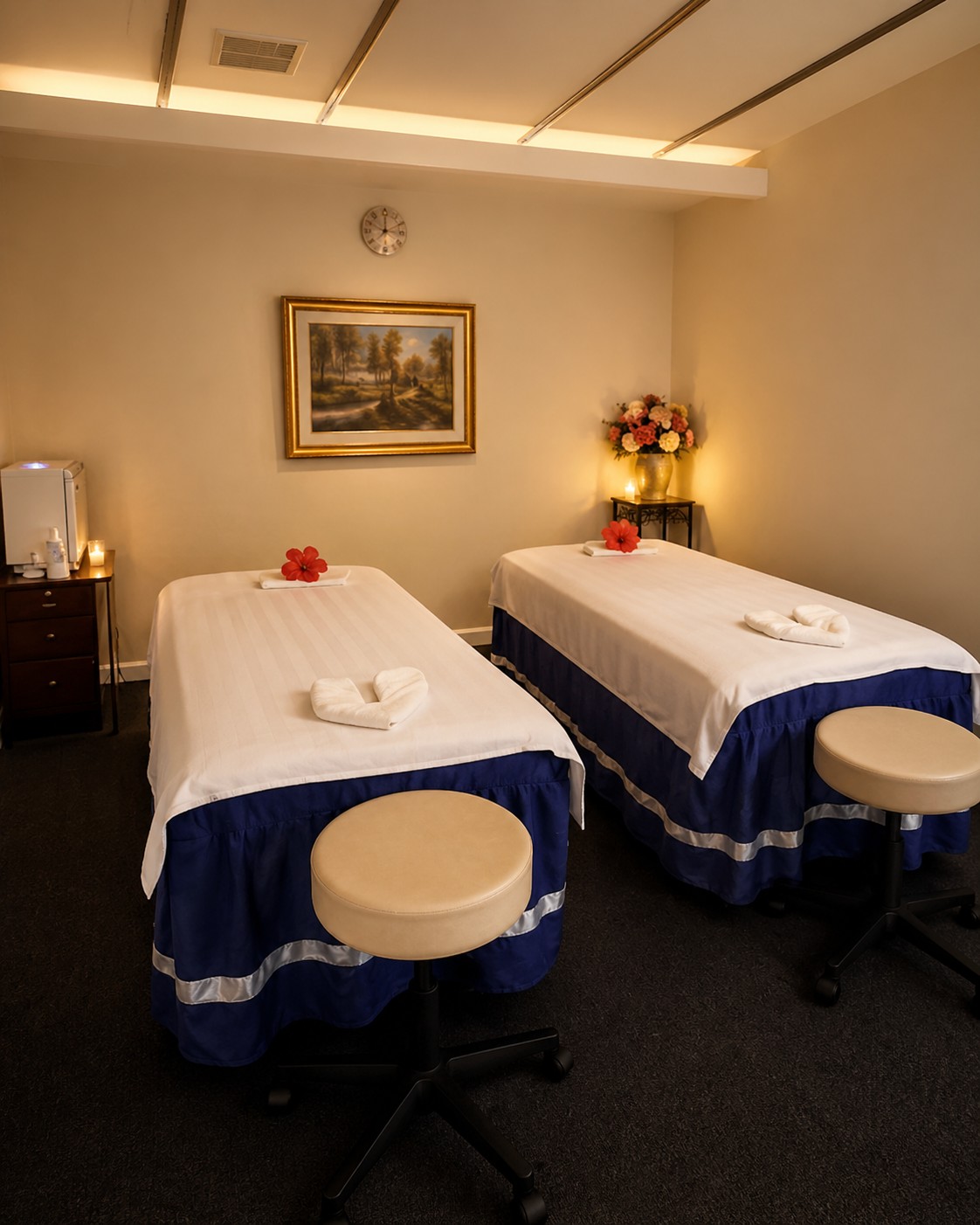 Side-by-side massage tables in a softly-lit Moon Spa couples room